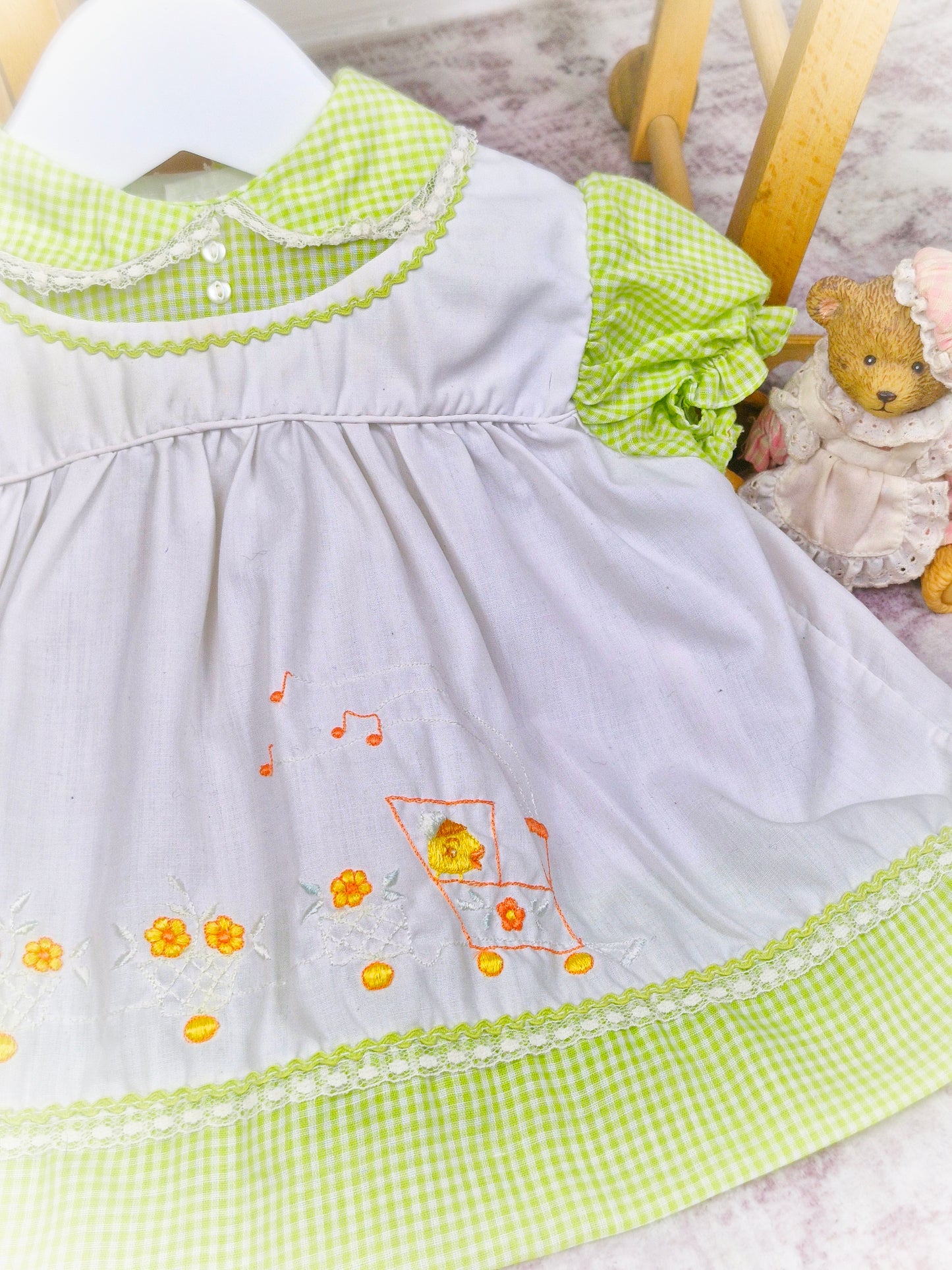 6-9 months. Green and white vintage gingham dress with embroidered ducks on a train