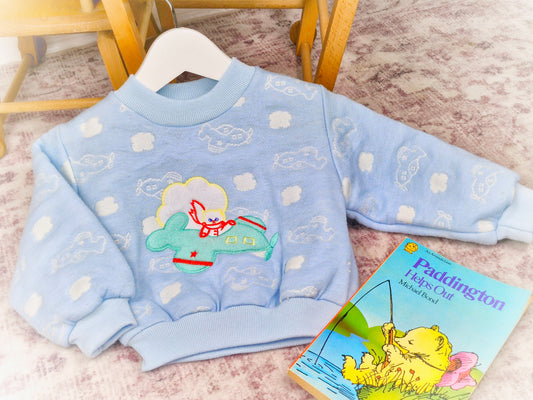 12-18 months. Blue vintage sweater from Cuties by Judy