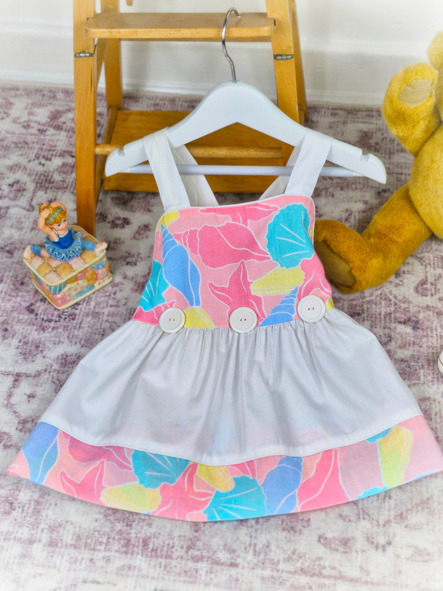 18-24 months. White vintage dress with colourful shell print, top layer unbuttons for different look!