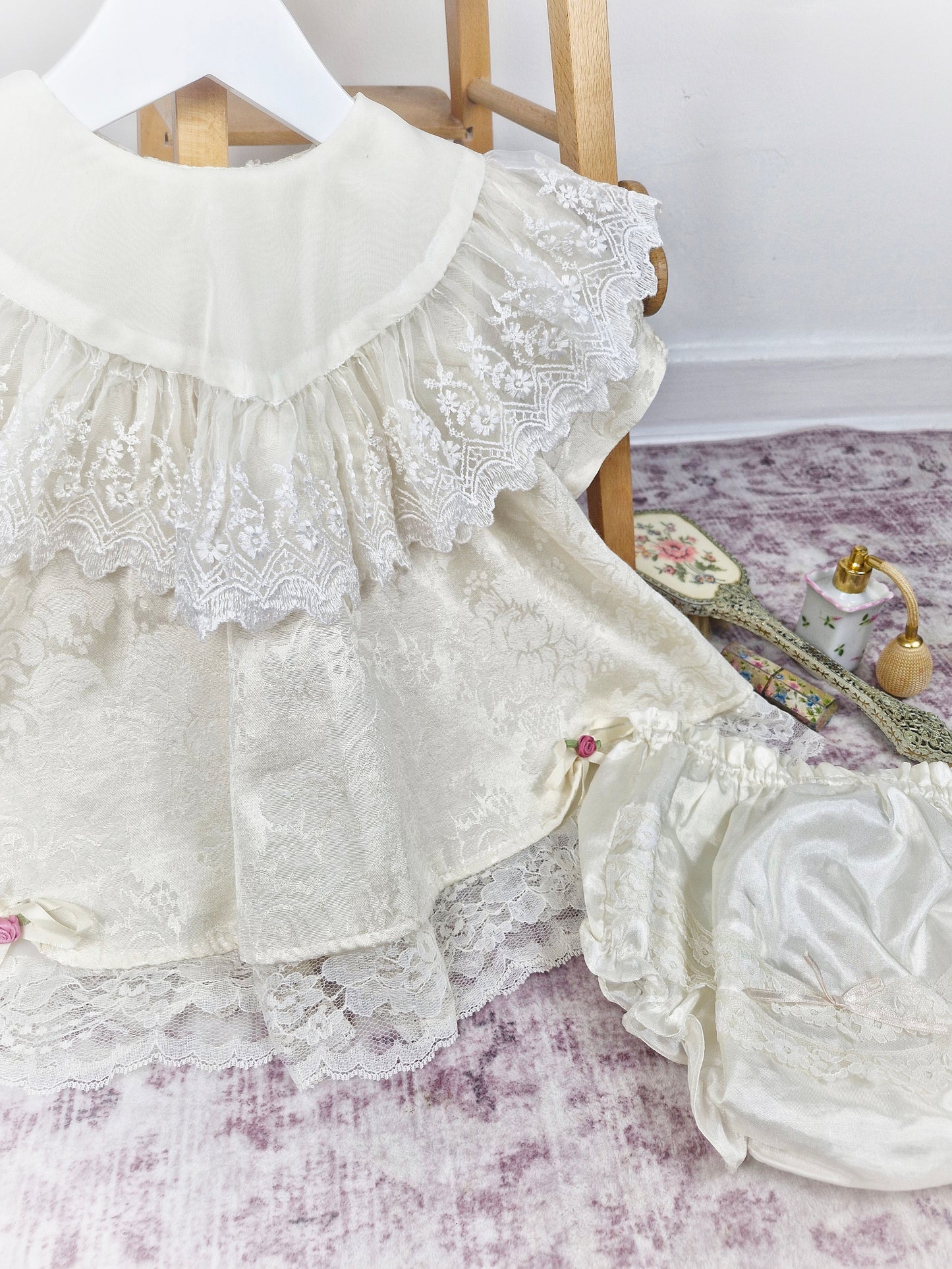 18-24 months/ 2 years. Cream vintage Bijan Kids with lace bib and hem, dusky pink rosettes and matching bloomers