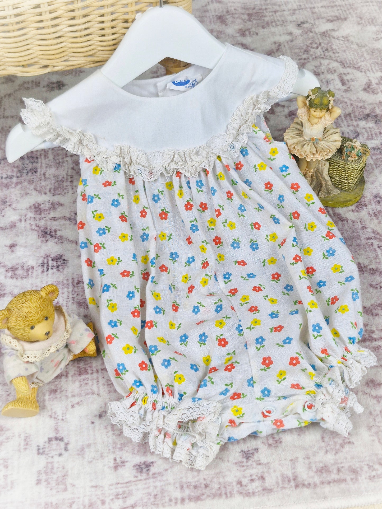 9-12 months. White vintage Bryan romper with floral print and white bib