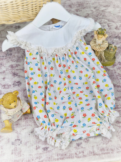 9-12 months. White vintage Bryan romper with floral print and white bib