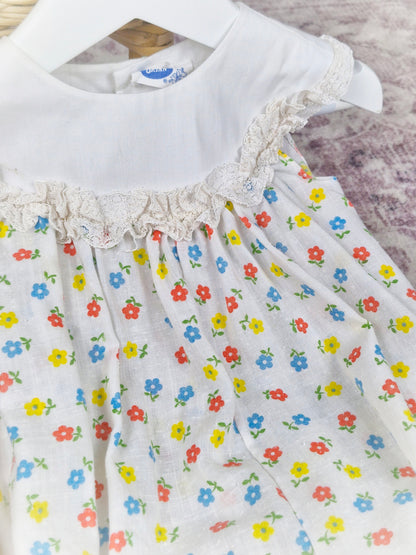 9-12 months. White vintage Bryan romper with floral print and white bib