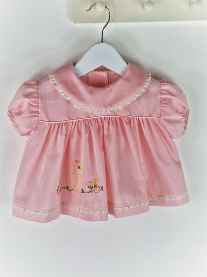 3-6 months. Pink vintage dress with lace hemmed bib and embroidered chick
