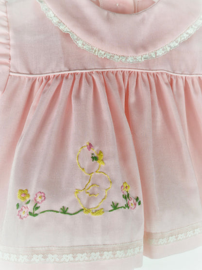 3-6 months. Pink vintage dress with lace hemmed bib and embroidered chick