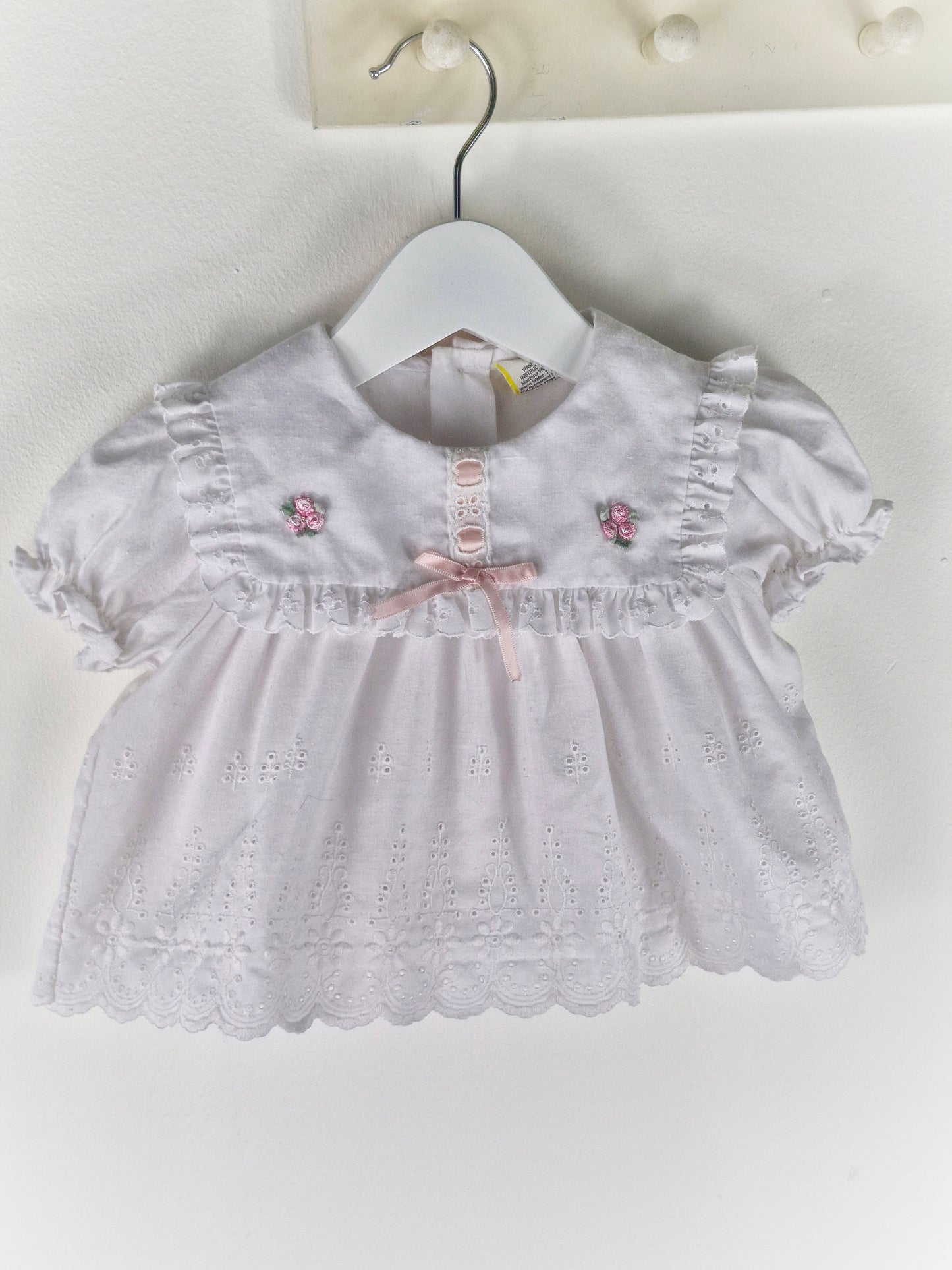 0-6 months. White vintage broderie anglais dress with pink satin ribbon