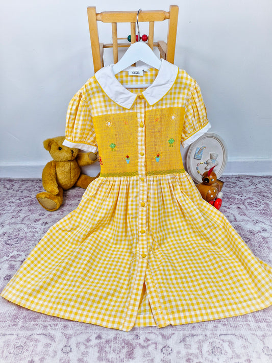 9-10 years. Yellow and white button down gingham smock dress with embroidered patterns
