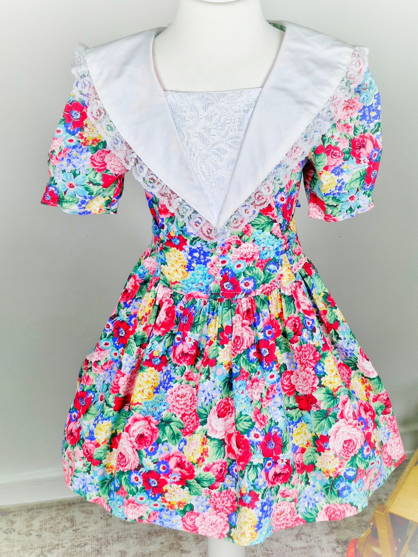 5 years. Vintage floral dress from Eve, too! With white collar/bib trimmed with lace and pearl details
