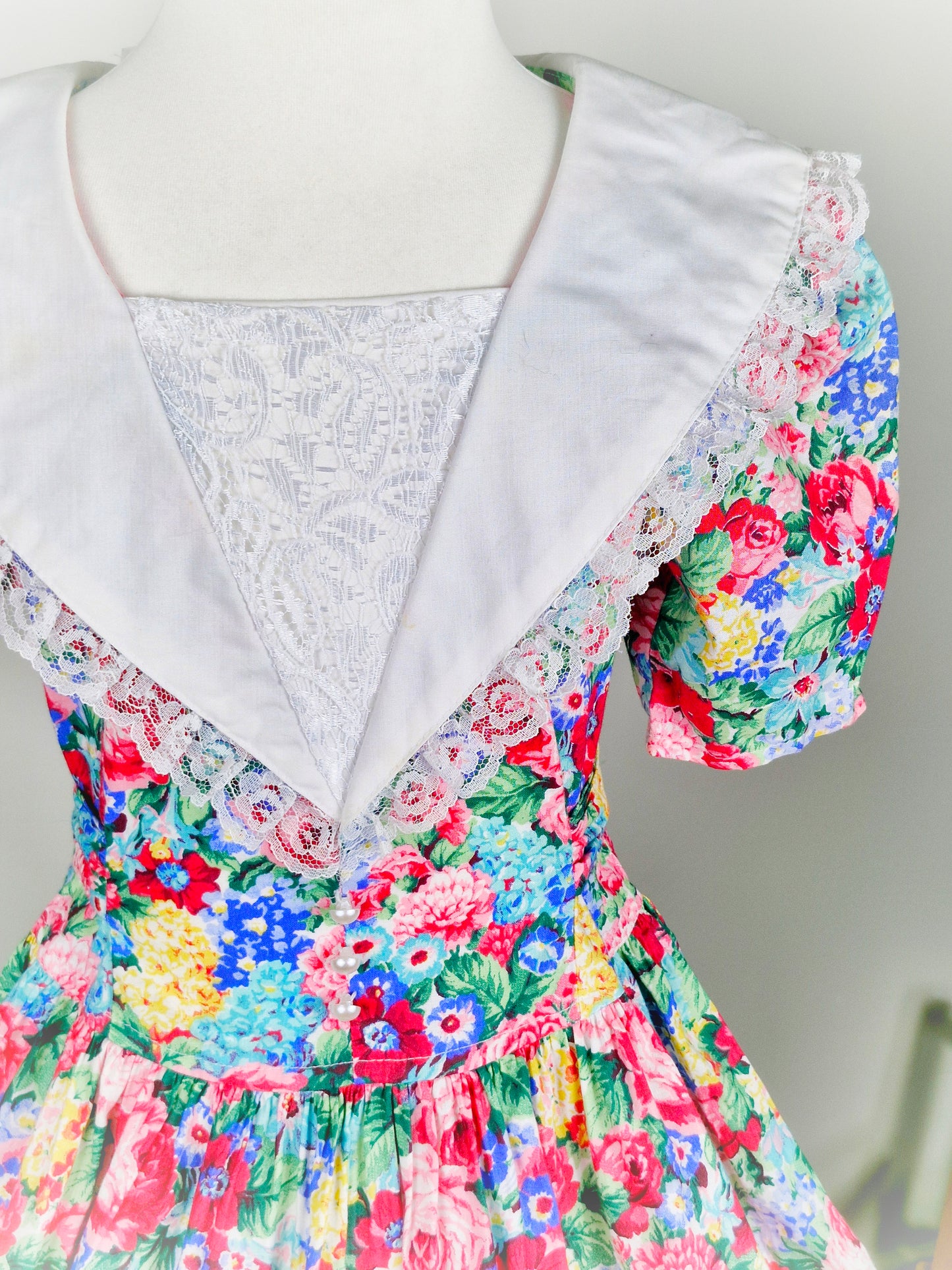 5 years. Vintage floral dress from Eve, too! With white collar/bib trimmed with lace and pearl details
