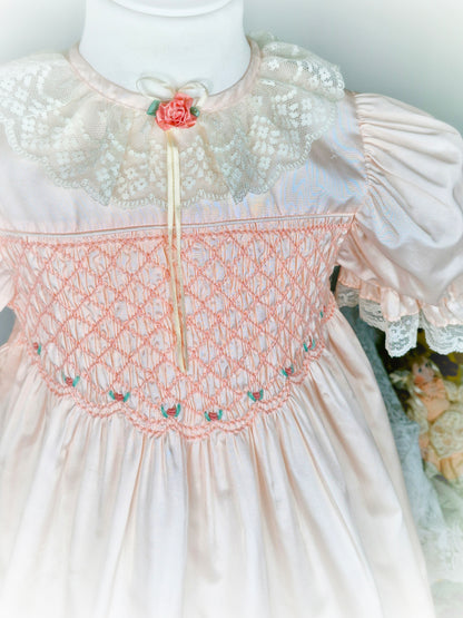 6-7 years. Peach Polly Flinders smock dress embroidered with flowers, with puff sleeves and lace collar