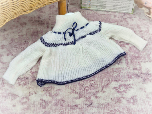 0-6 months. High-neck knit jumper with blue design