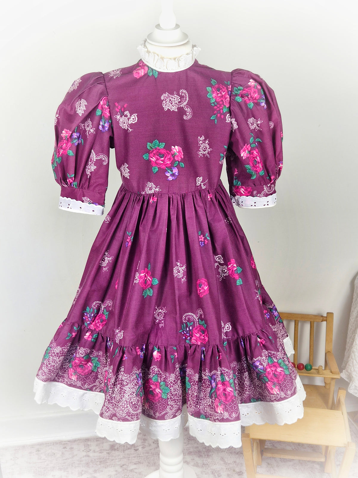 7 years. Handmade Daisy Kingdom dress, burgundy with floral designs