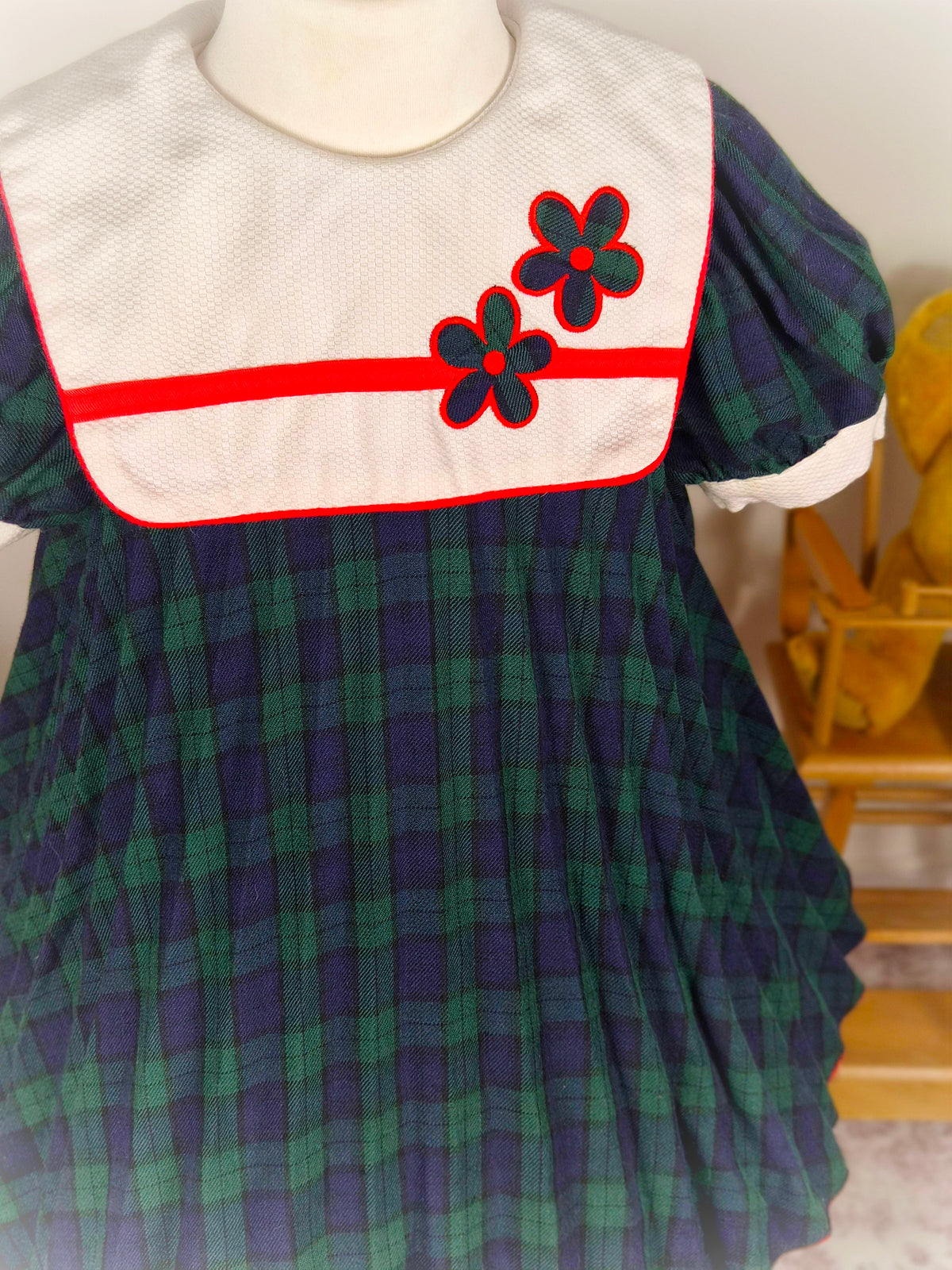 3 years. Navy and green tartan vintage dress from Thomas with mini pleats, white bib and floral designs
