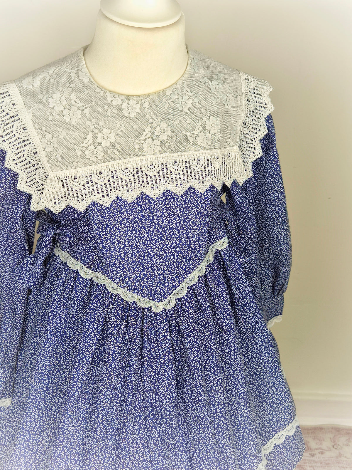 3-4 years. Navy blue vintage dress with white floral patterns from Special Occasions with white lace bib and trim
