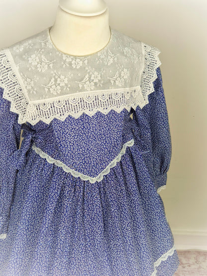 3-4 years. Navy blue vintage dress with white floral patterns from Special Occasions with white lace bib and trim