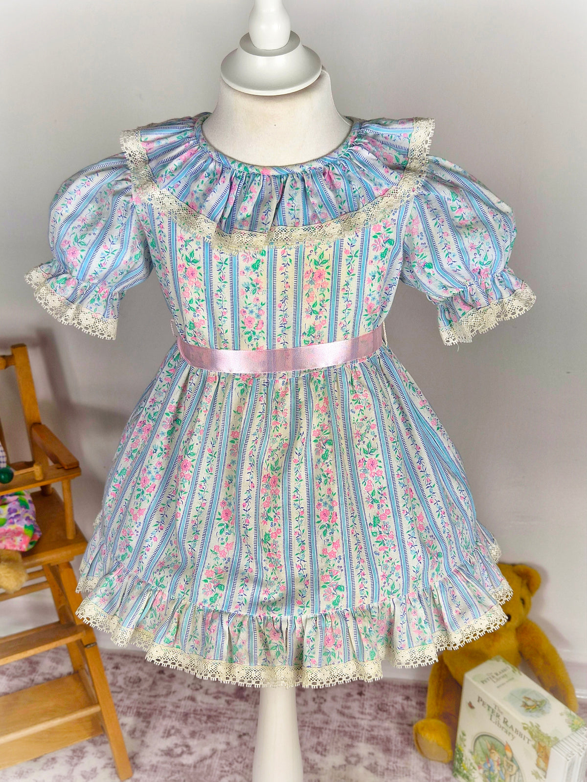 2 years. White vintage dress with blue stripes, pink flowers & belt and lace trim