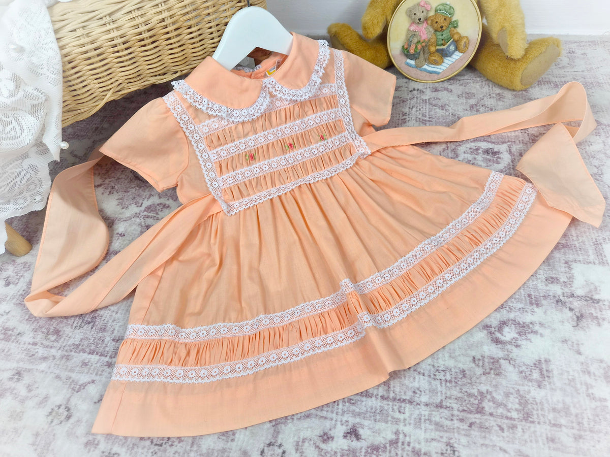 18-24 months. Peach vintage smock Michael de Leon dress with white lace and dainty embroidered flowers