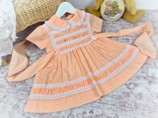 18-24 months. Peach vintage smock Michael de Leon dress with white lace and dainty embroidered flowers