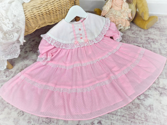 2 years. Pink vintage dress with white polka dots, frills and bib