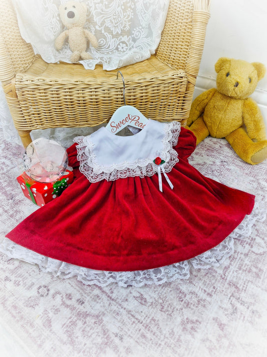 6-9 months. Red velour vintage Bryan dress with white frill bib and red rosette