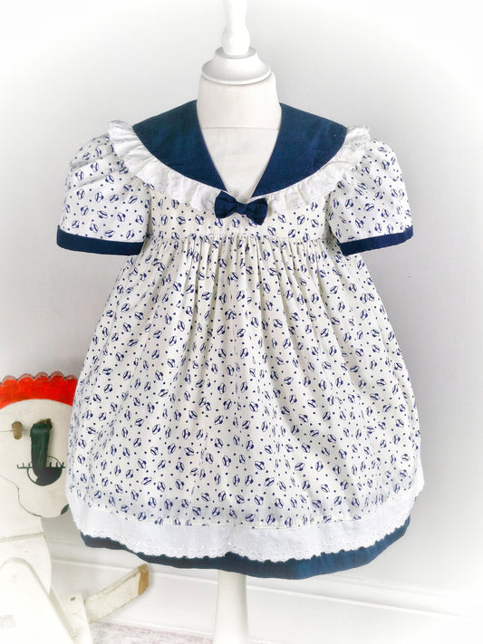 3-4 years. White vintage dress with navy sailor hat print, navy collar and bow