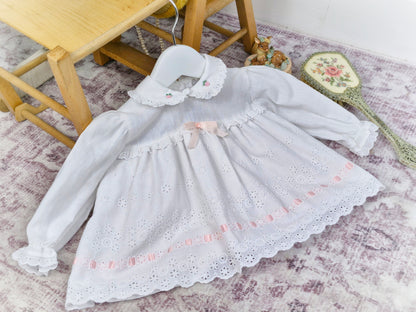 6-9 months. White vintage dress with long sleeves, eyelet details and pink satin ribbon