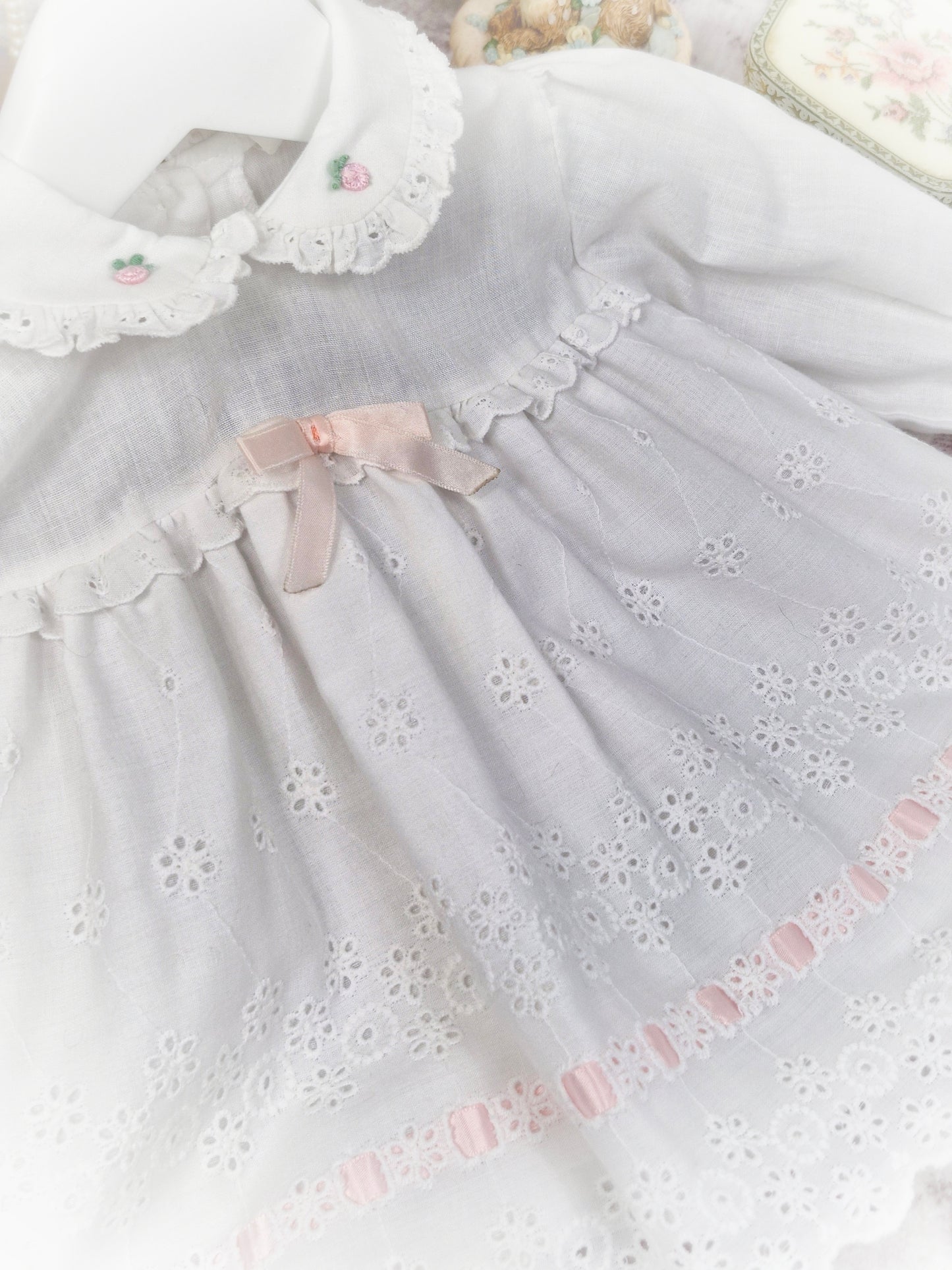 6-9 months. White vintage dress with long sleeves, eyelet details and pink satin ribbon
