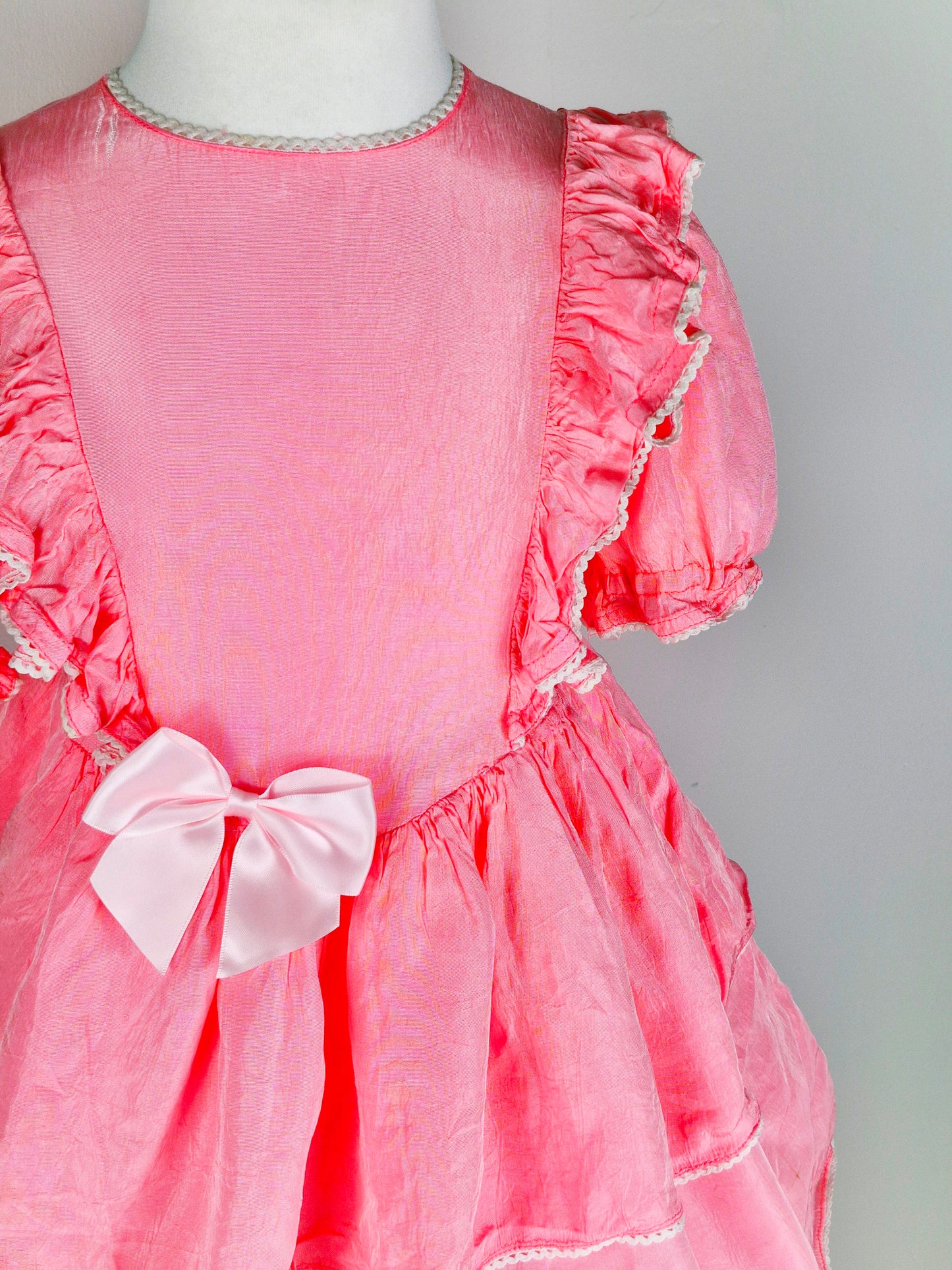 4-5 years. Pink handmade dress with ruffles and a lighter pink satin bow