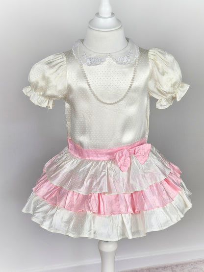 3 years. White satin drop waist vintage dress with pink bow and layers, puff sleeves and pearl faux necklace