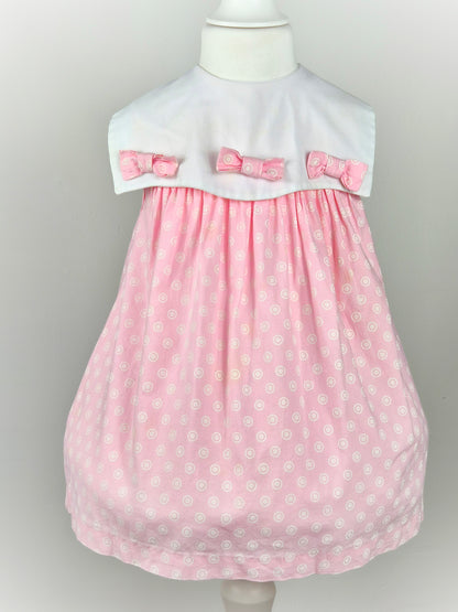 2-3 years. Pink sleeveless vintage dress with white bib and three bows