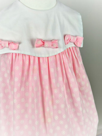 2-3 years. Pink sleeveless vintage dress with white bib and three bows