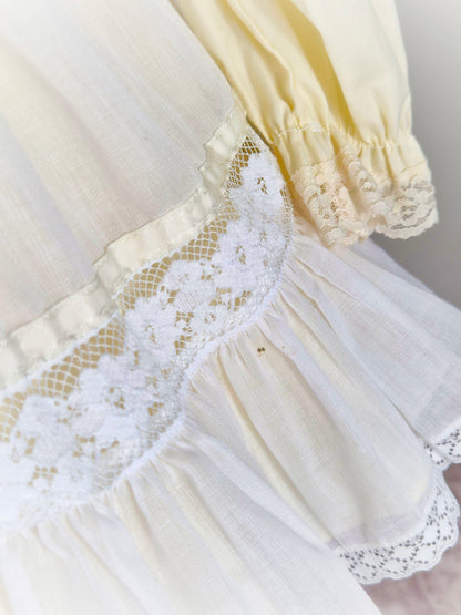 2 years. Two piece vintage Bryan set, creamy lemon long sleeve dress with white pinny trimmed with lace and ribbon