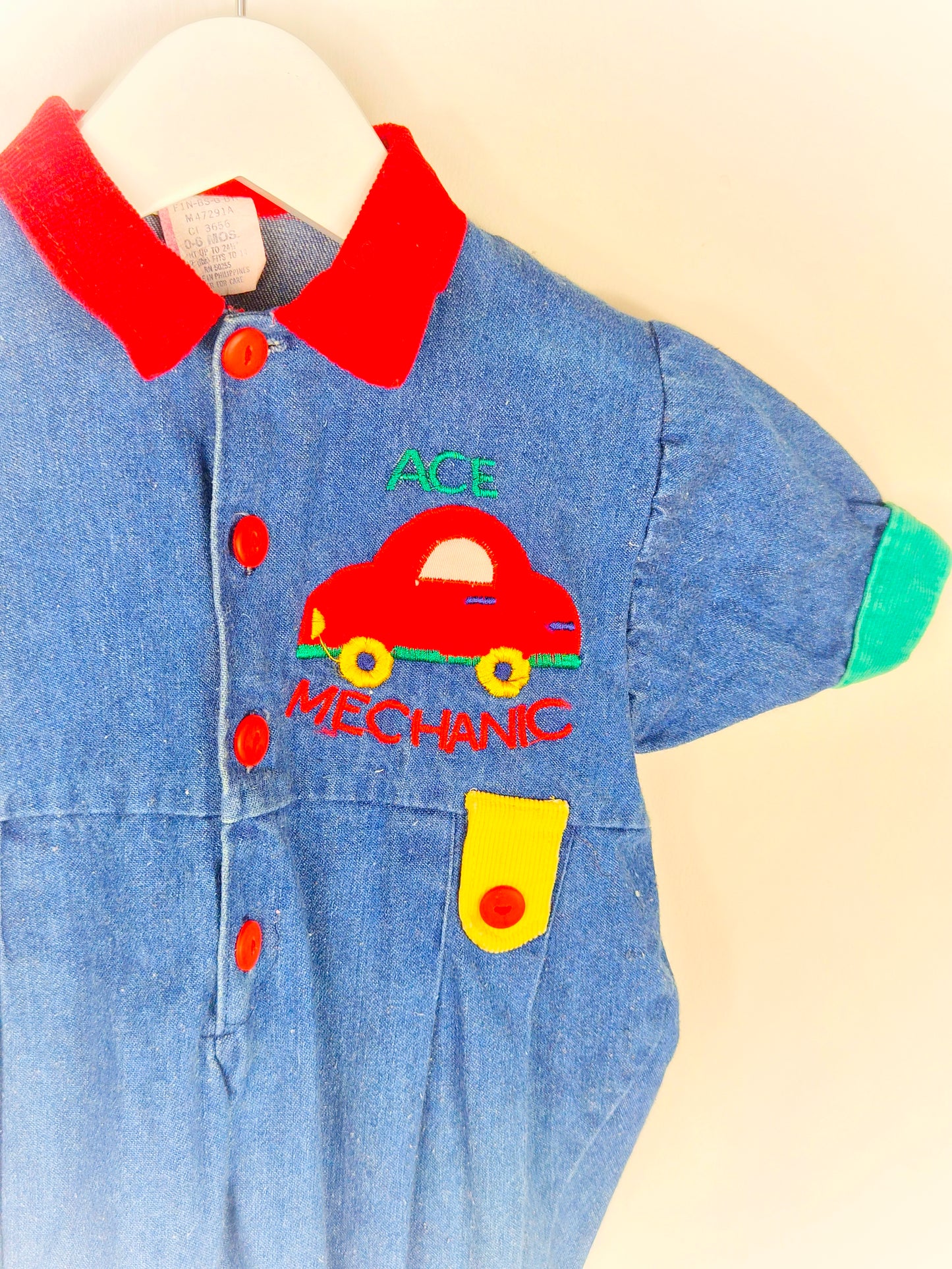 6 months. Denim romper with car applique and primary colour details