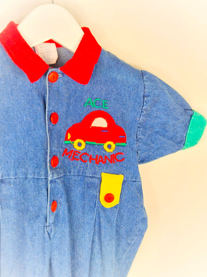 6 months. Denim romper with car applique and primary colour details