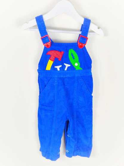 12 months. Blue corduroy dungarees with red adjustable buckles and tools