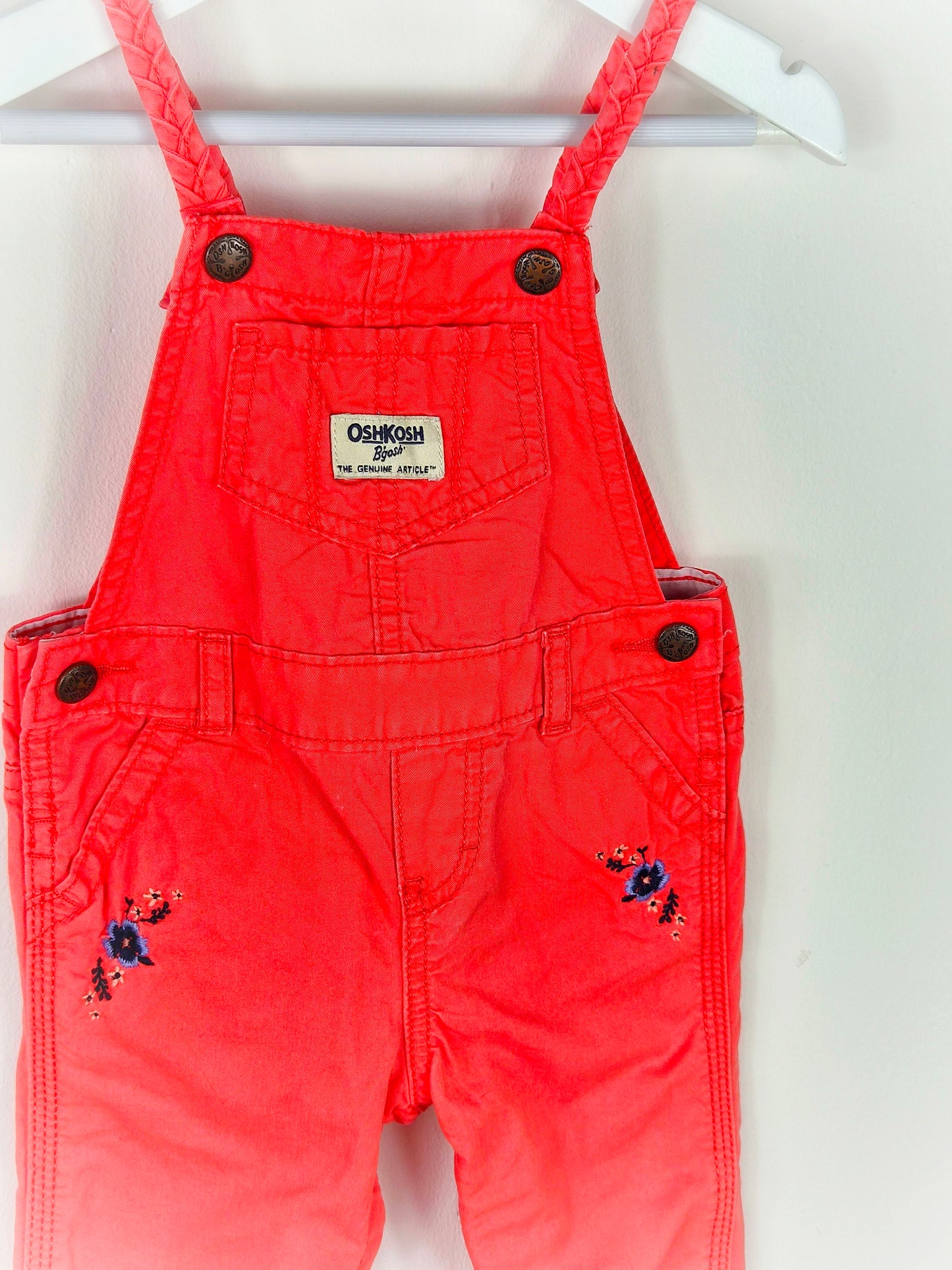 12 months. Coral Oshkosh dungarees with embroidered flowers and braided straps