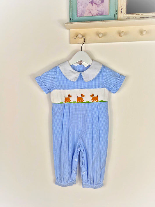 12-18 months. Blue and white gingham smocked romper with embroidered dogs and whi5e collar