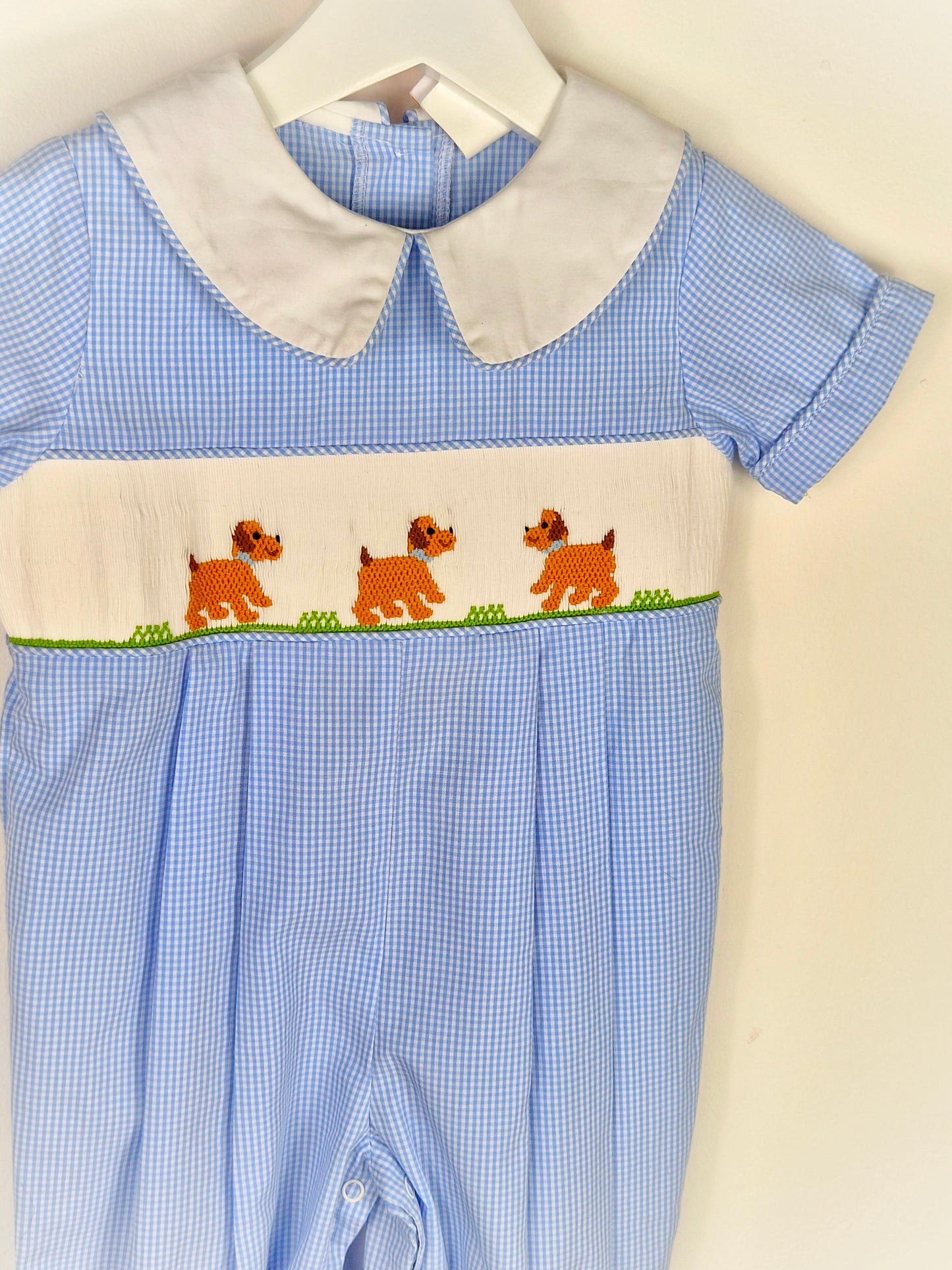 12-18 months. Blue and white gingham smocked romper with embroidered dogs and whi5e collar