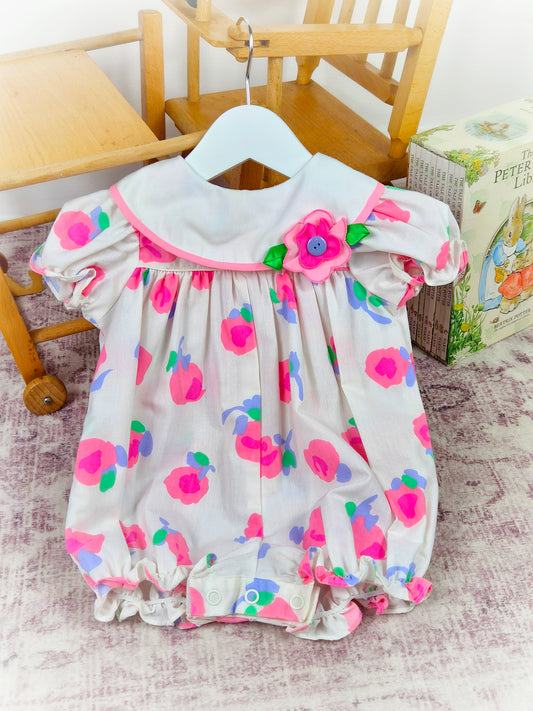 9-12 months. White vintage short romper with pink and purple flowers and puff sleeves