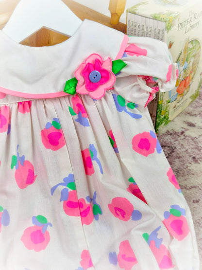 9-12 months. White vintage short romper with pink and purple flowers and puff sleeves