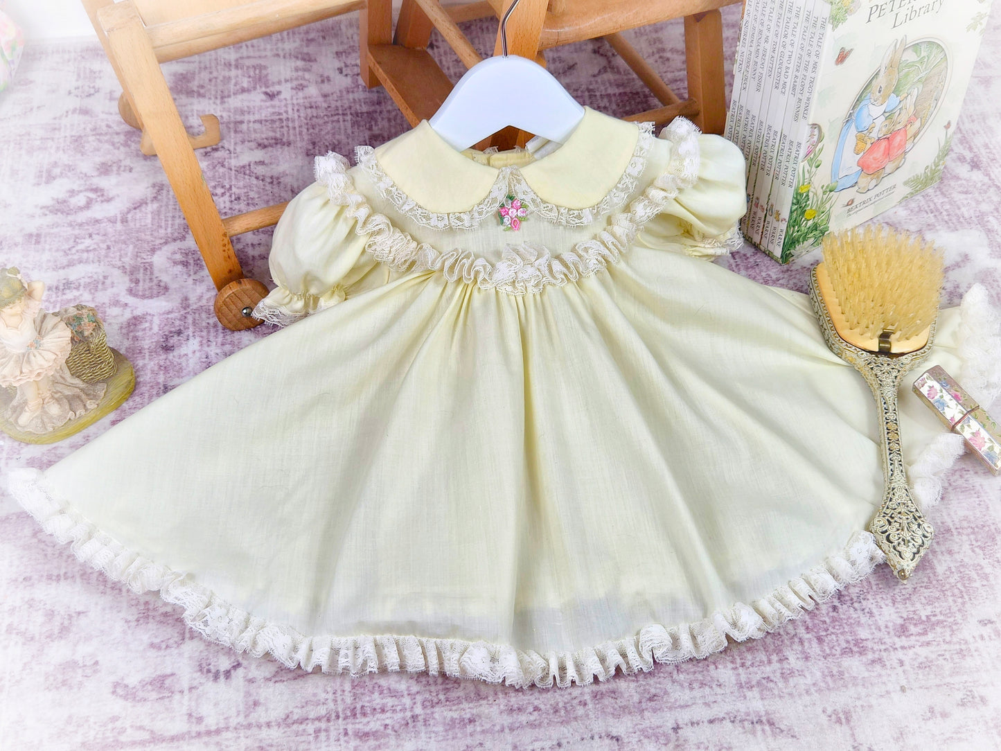 9-12 months. Lemon vintage Bryan with fluffy lace trim