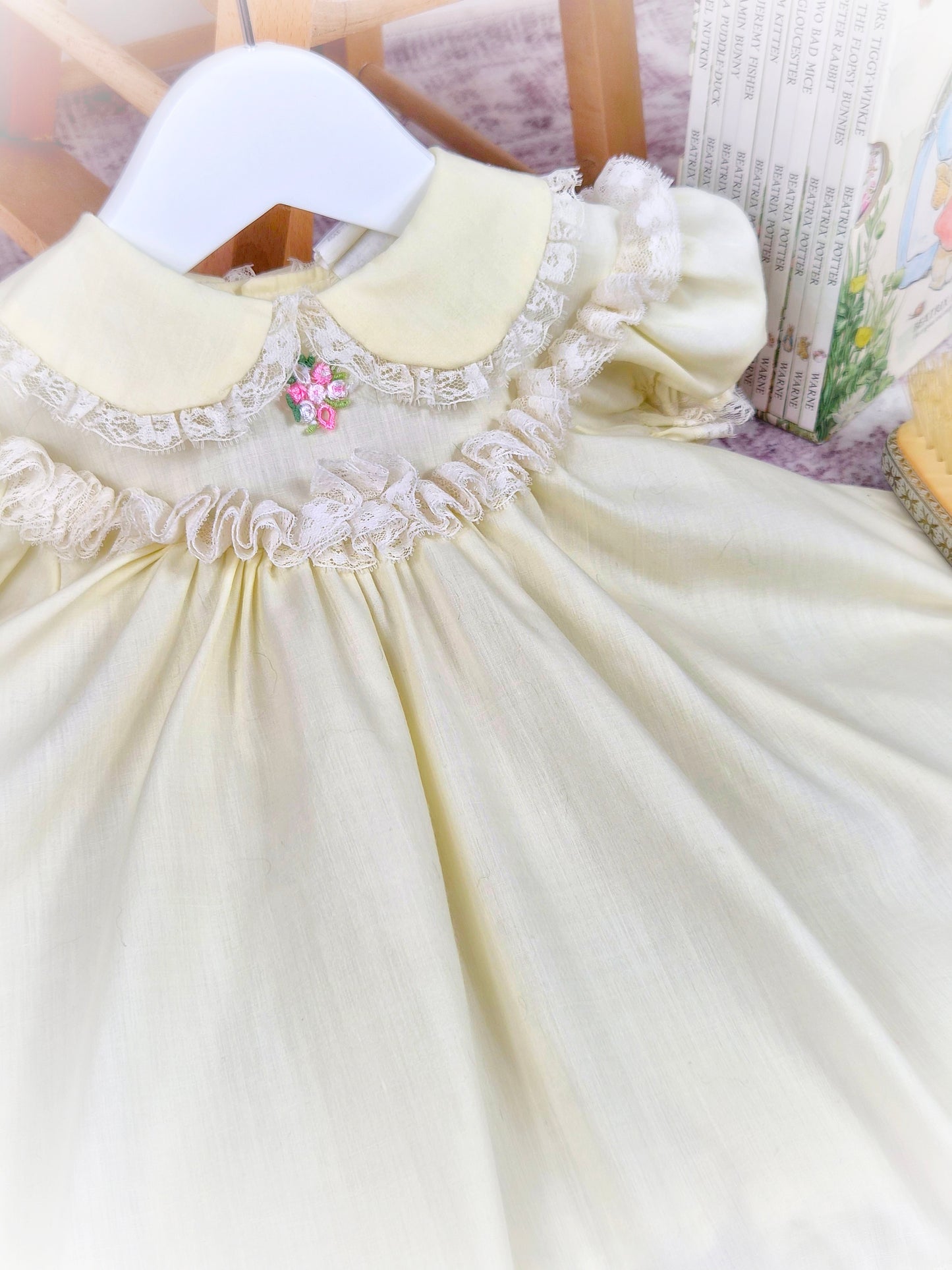 9-12 months. Lemon vintage Bryan with fluffy lace trim