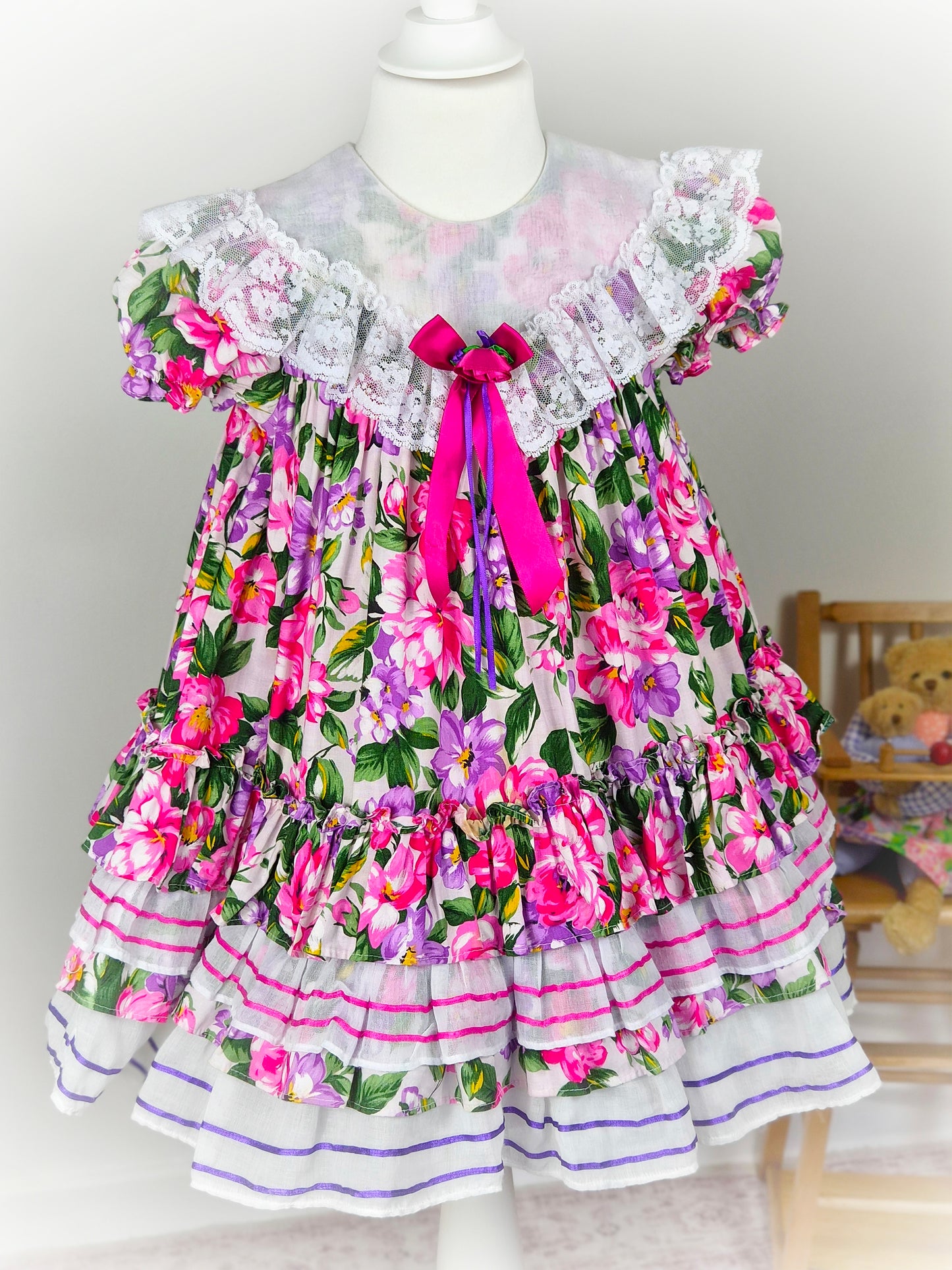 3-4 years. Tiered floral vintage Jolene with large white bib, lace and ribbon