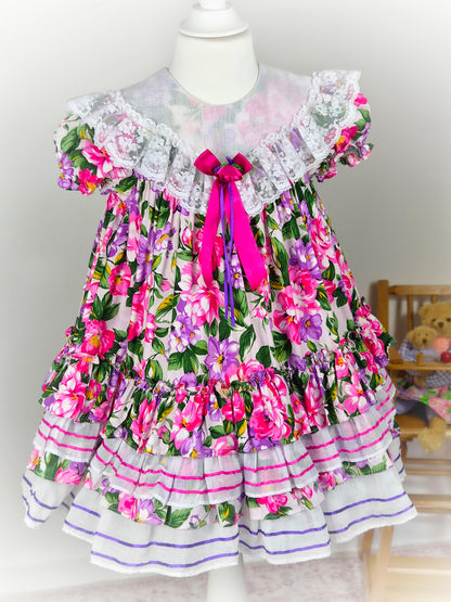 3-4 years. Tiered floral vintage Jolene with large white bib, lace and ribbon
