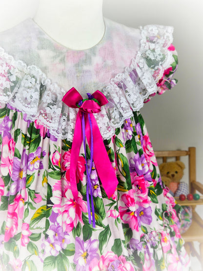 3-4 years. Tiered floral vintage Jolene with large white bib, lace and ribbon