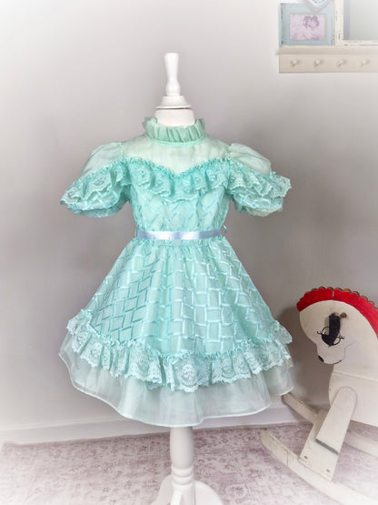 4-5 years. Mint vintage frilly dress with high neck, sheer chest and white ribbon
