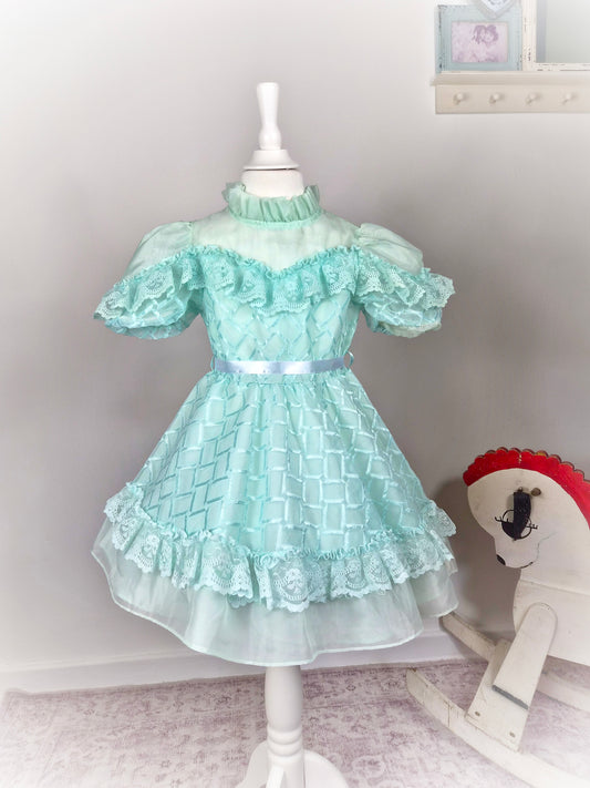 4-5 years. Mint vintage frilly dress with high neck, sheer chest and white ribbon