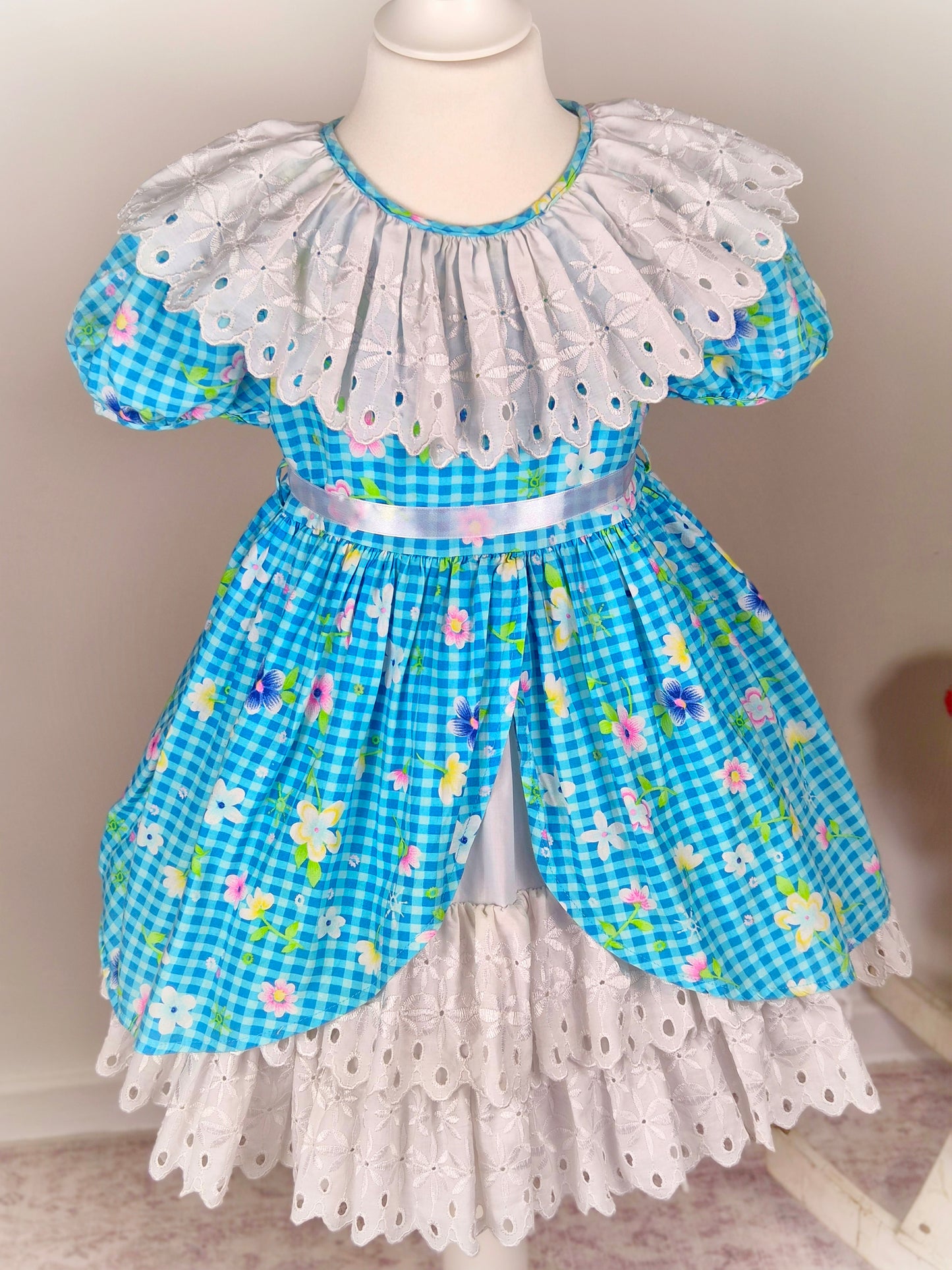 4 years. Blue gingham vintage dress with floral design, large white ruffled bib and ruffle eyelet layers
