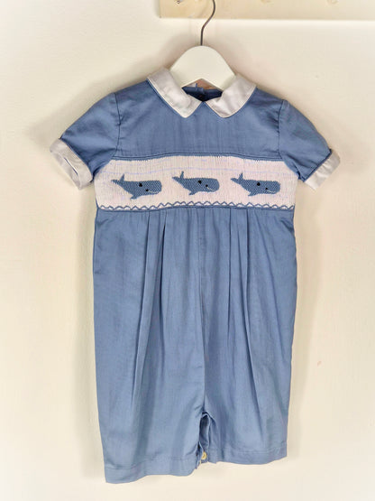 12-18 months. Blue smocked romper with embroidered whales and white peter pan collar