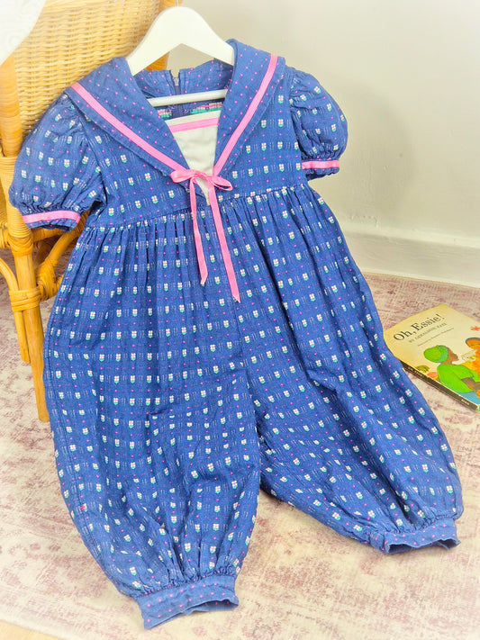 2-3 years. Blue vintage romper with pink satin ribbon and floral details